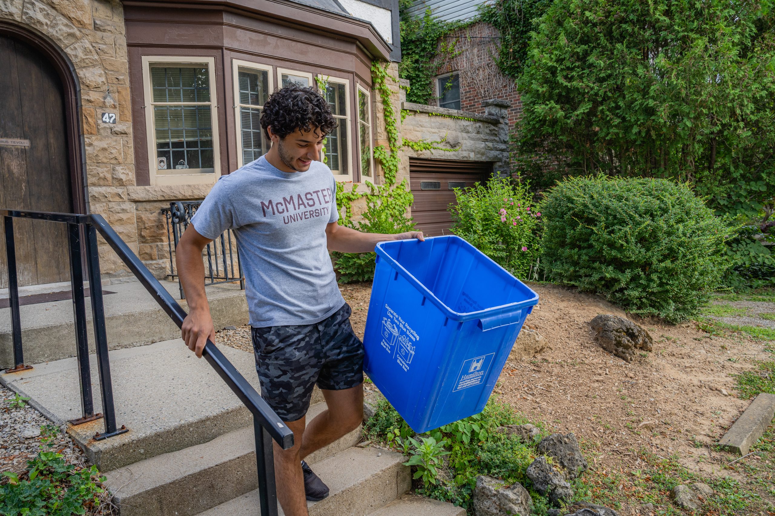 man taking out recycling bin